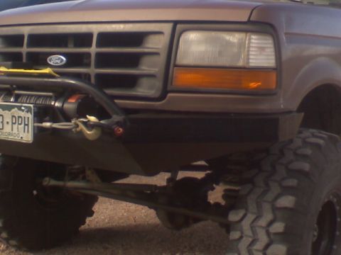 1993 Ford Bronco - Front view of a brown Ford Bronco with a winch mounted on the aftermarket bumper.