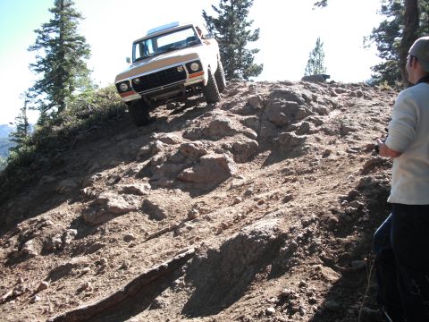1991 Ford Bronco - A 1978 Ford Bronco navigates a steep, rocky incline on a trail.