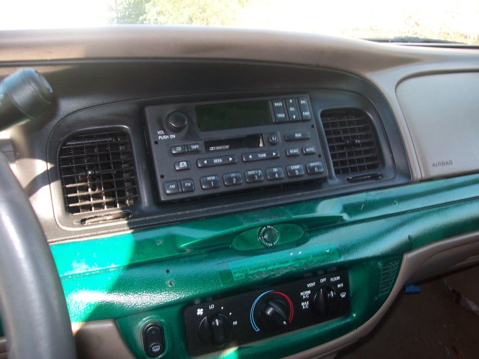 2004 Ford Crown Victoria interior dashboard with green painted trim and factory radio