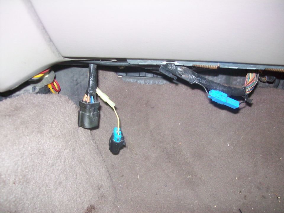 Car interior wiring harness with blue connectors and black tape