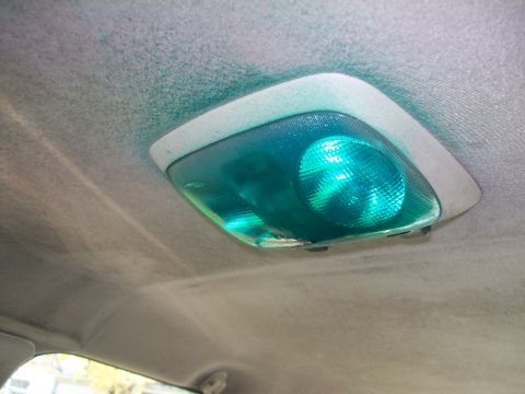 2004 Ford Crown Victoria - Close-up of a car's interior dome light with green bulbs illuminated.