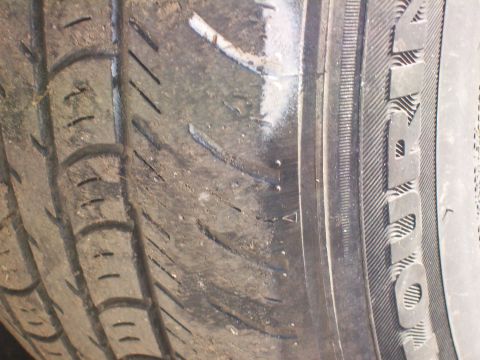 2004 Ford Crown Victoria - Tire tread detail with sidewall markings visible.