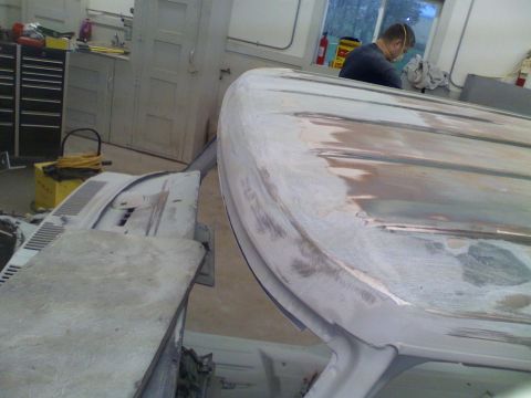 1979 Ford F-250 - A car's hood is being prepped for paint in a workshop.
