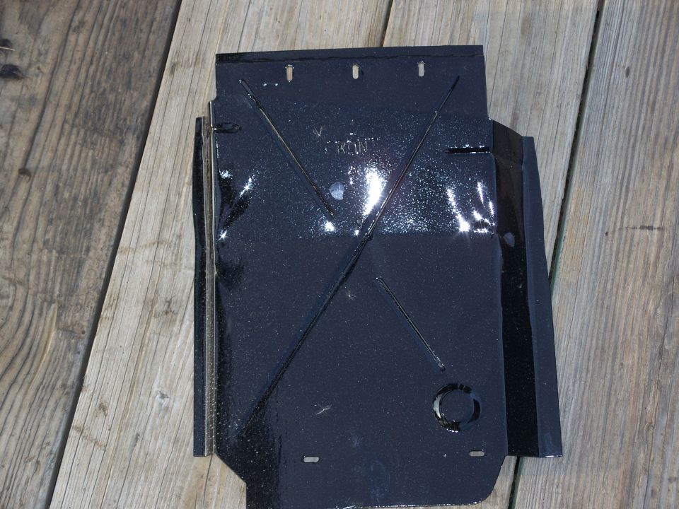 Black metal part with embossed lines and the word "FRONT" visible