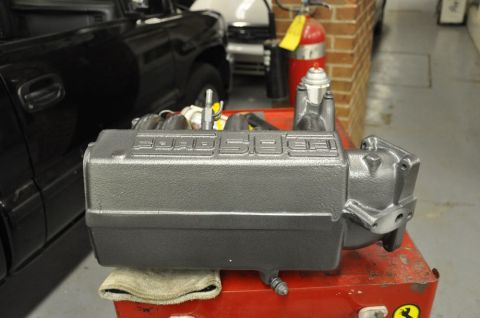 1996 Ford Bronco - Gray Ford 5.8L engine intake manifold on a red toolbox, with a black truck visible in the background.