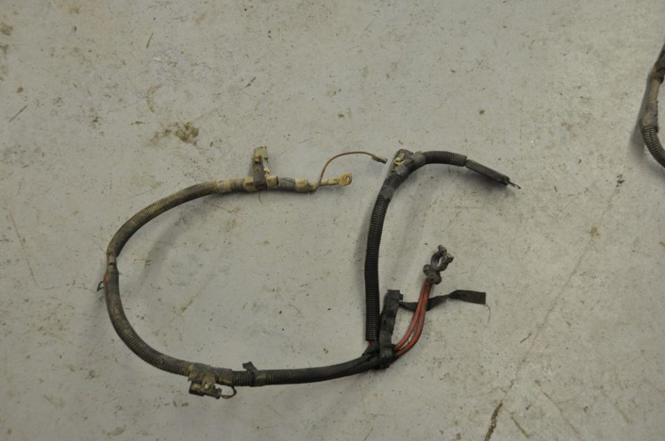 Automotive wiring harness with corrugated tubing and connectors on a concrete floor