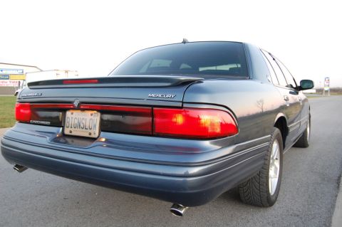 1985 Mercury Grand Marquis - This Mercury Grand Marquis features a spoiler and dual exhaust pipes, with a personalized license plate.