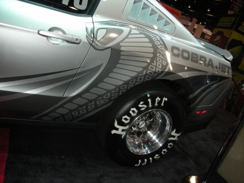1998 Ford Crown Victoria - A silver Ford Mustang Cobra Jet is shown from the side with racing tires and custom graphics.