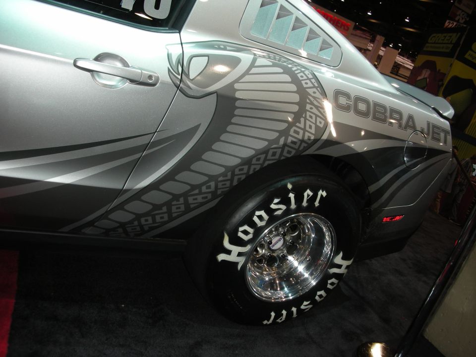 Silver Ford Mustang Cobra Jet with a large cobra graphic and "Cobra Jet" text on the side