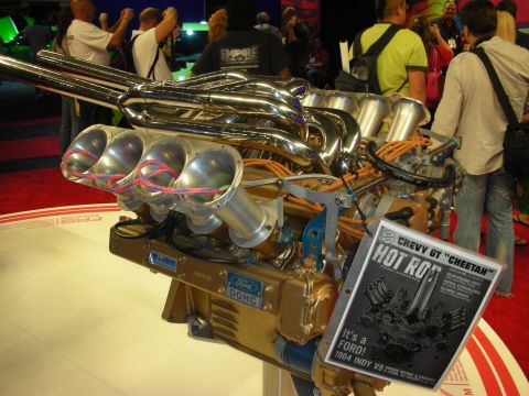 1998 Ford Crown Victoria - A Ford DOHC V8 engine is displayed with a magazine cover identifying it as a 1964 Indy V8.
