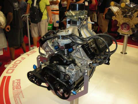 1998 Ford Crown Victoria - A Ford FR9 Evolution engine is displayed on a stand, with text indicating it is by Ford.