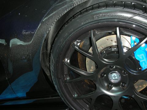 1998 Ford Crown Victoria - Carbon fiber bodywork and aftermarket wheel with blue calipers are visible on this vehicle.