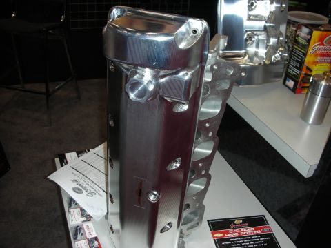 1998 Ford Crown Victoria - A polished aluminum cylinder head, likely for a Ford engine, is displayed with branding and product information.