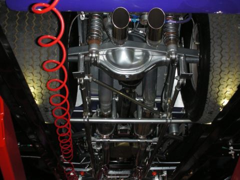 1998 Ford Crown Victoria - The detailed undercarriage of a custom vehicle showcases its polished rear axle and exhaust system.
