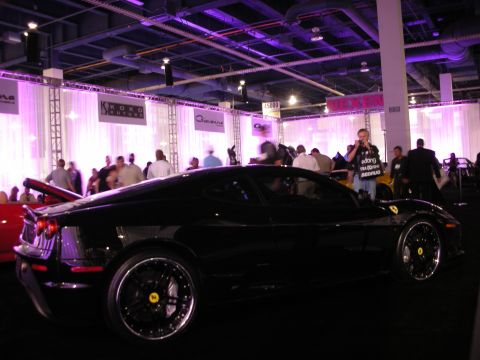 1998 Ford Crown Victoria - Black Ferrari 430 at an indoor event with multiple people visible.