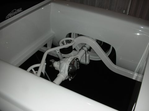 1998 Ford Crown Victoria - Close-up view of the custom white rear suspension and differential on a pickup truck.