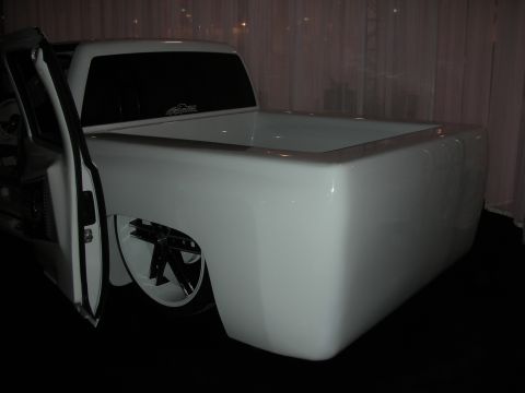 1998 Ford Crown Victoria - Customized pickup truck with a unique bed design and large aftermarket wheels.