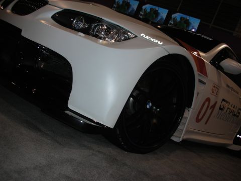 1998 Ford Crown Victoria - A close-up view of a white BMW M3 GT2 race car, highlighting its aggressive styling and racing decals.