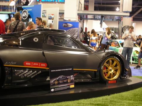 1998 Ford Crown Victoria - Pagani Zonda F on display, carbon fiber construction and gold multi-spoke wheels.