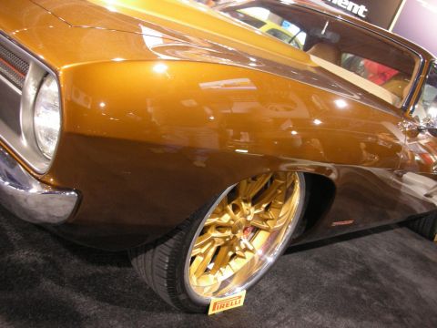 1998 Ford Crown Victoria - A customized car with striking gold accents and custom wheels is displayed.