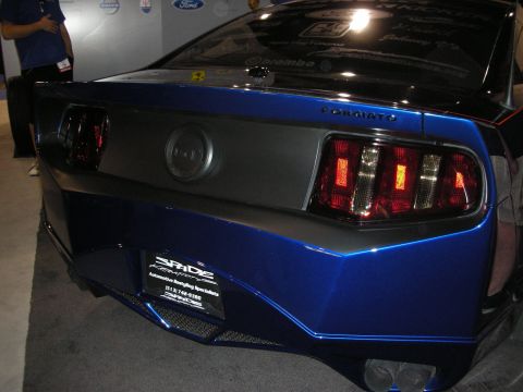 1998 Ford Crown Victoria - The rear of a blue Ford Mustang shows off its custom taillights and Spade Customs branding.