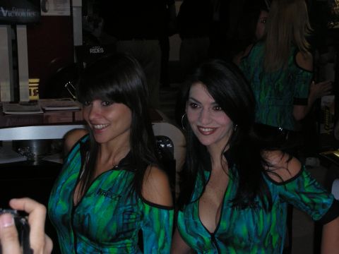 1998 Ford Crown Victoria - Two women pose for a photo at an event, both wearing similar outfits.