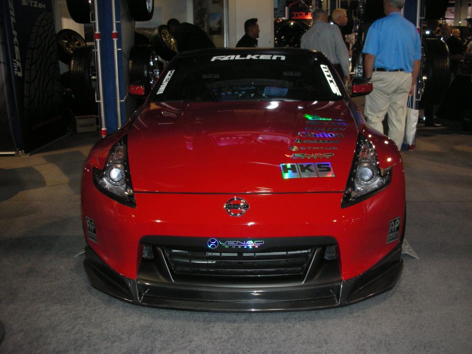 Red sports car with racing decals on the hood and front bumper