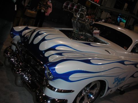 1998 Ford Crown Victoria - A heavily modified car with a prominent supercharger and custom flame paint job is displayed.