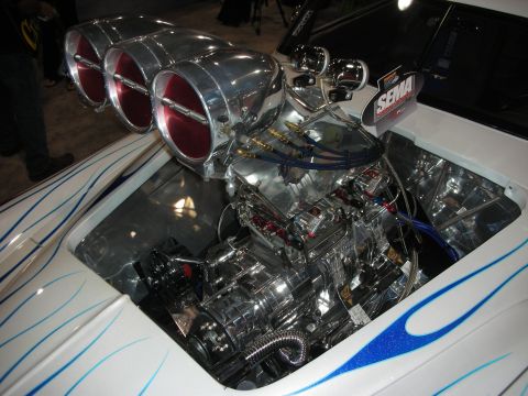 1998 Ford Crown Victoria - Custom hot rod engine with chrome blower and triple carburetors, white body with blue flames.