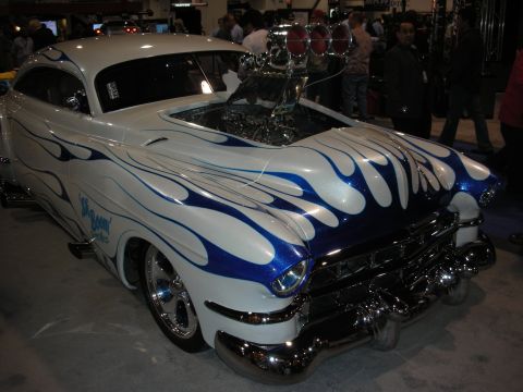 1998 Ford Crown Victoria - A heavily modified hot rod with a prominent supercharger and custom paint job is on display.