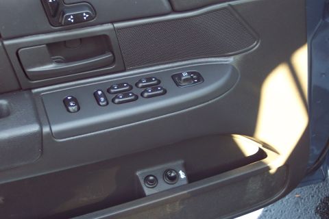 2001 Ford Crown Victoria - Interior door panel of a 2001 Ford Crown Victoria, power window and mirror controls.