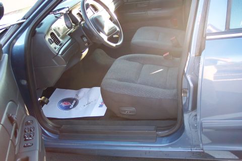 2001 Ford Crown Victoria - Interior view of a blue 2001 Ford Crown Victoria, highlighting the driver's side and front passenger seat.