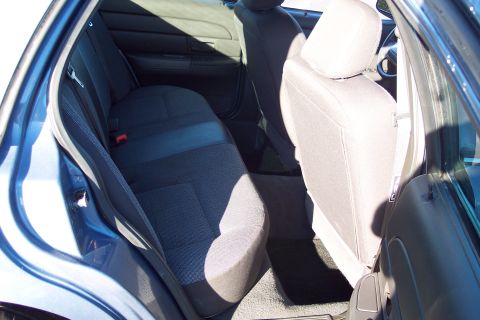 2001 Ford Crown Victoria - Interior view of the rear seats and door panel of a blue 2001 Ford Crown Victoria.