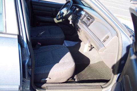 2001 Ford Crown Victoria - Interior view of a blue 2001 Ford Crown Victoria, highlighting the driver's side dashboard and seating.