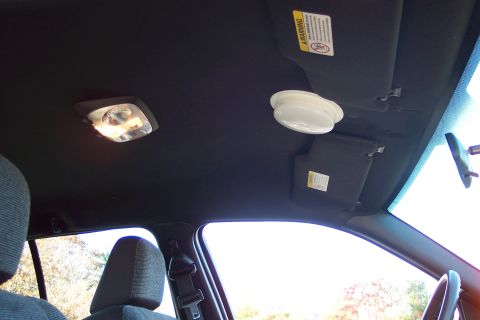2001 Ford Crown Victoria - Interior view of car ceiling showing dome lights and sun visors.