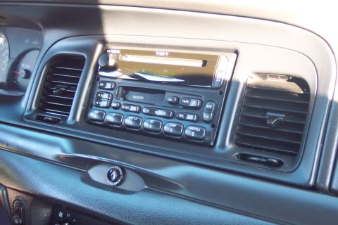2001 Ford Crown Victoria - The interior of a 2001 Ford Crown Victoria features a standard radio and climate control vents.