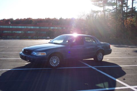 2001 Ford Crown Victoria - A 2001 Ford Crown Victoria is parked in a lot on a sunny day.