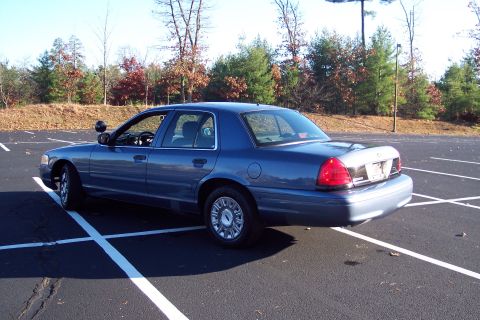 2001 Ford Crown Victoria - This 2001 Ford Crown Victoria sedan is shown from the rear quarter angle in a parking lot.