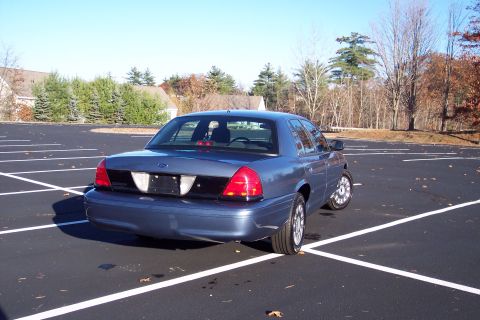 2001 Ford Crown Victoria - This 2001 Ford Crown Victoria is seen from the rear in an empty parking lot on a clear day.