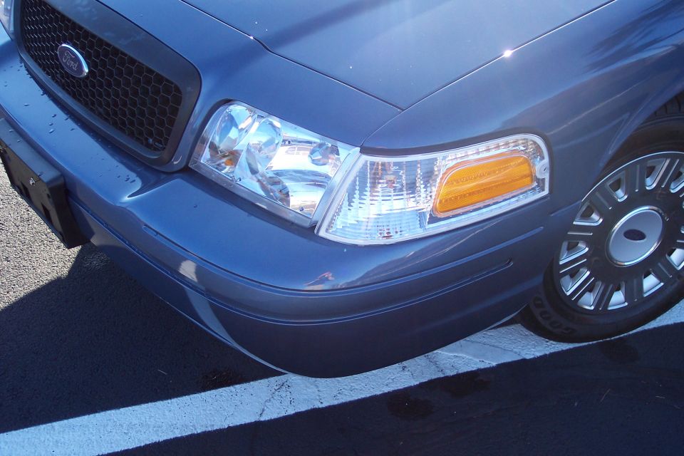 Blue 2001 Ford Crown Victoria front corner with grille and headlight visible