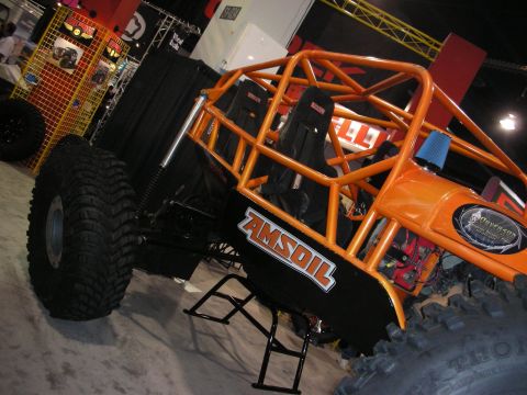 1998 Ford Crown Victoria - This custom off-road vehicle features a prominent orange roll cage and AMSOIL decals on its side panels.