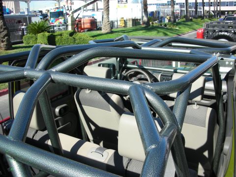 1998 Ford Crown Victoria - Custom roll cage installed in a Jeep's interior, with seats and dashboard visible.