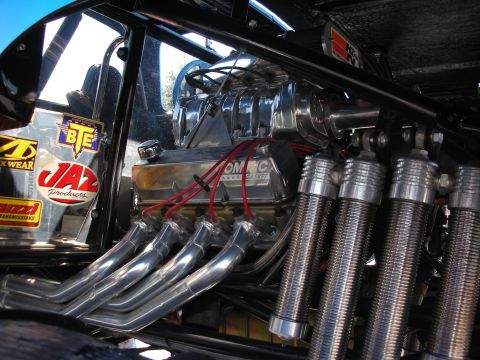 1998 Ford Crown Victoria - Close-up view of a modified engine with a prominent supercharger and custom exhaust system.