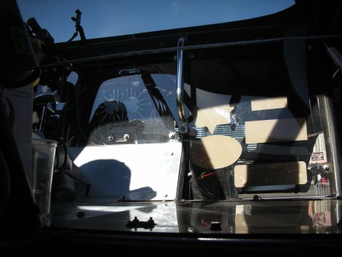 1998 Ford Crown Victoria - Interior view of a vehicle, showing a grab handle and a fan behind the windshield.