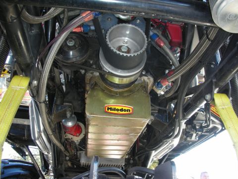 1998 Ford Crown Victoria - Close-up view of a Milodon oil pan and associated engine components.