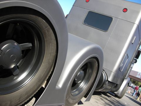 1998 Ford Crown Victoria - A custom gray semi-truck is viewed from a low angle, focusing on its rear wheels and fenders.