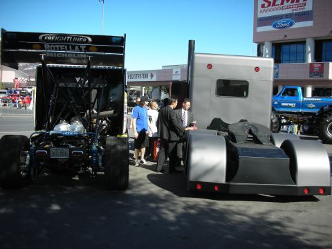 1998 Ford Crown Victoria - A dragster and a semi-truck cab are parked side-by-side, with a monster truck visible in the background.