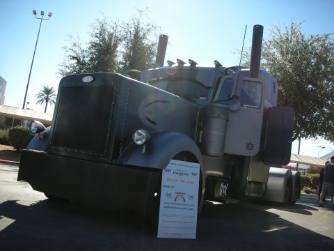 1998 Ford Crown Victoria - A Peterbilt 379 truck is displayed with a 'Trucks for Sale' sign in front of it.