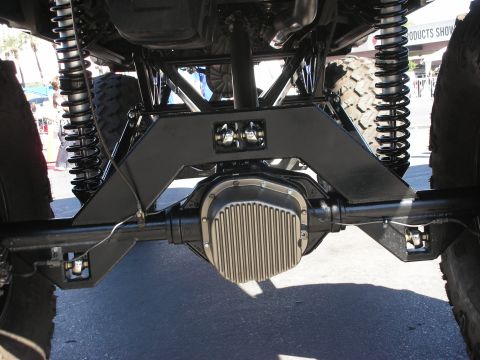 1998 Ford Crown Victoria - Close-up view of the heavy-duty rear axle and suspension system on a modified vehicle.