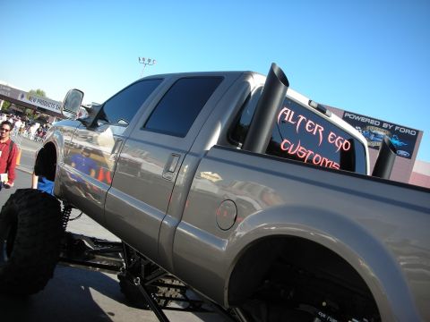 1998 Ford Crown Victoria - This heavily modified pickup truck features custom paint and large exhaust stacks.
